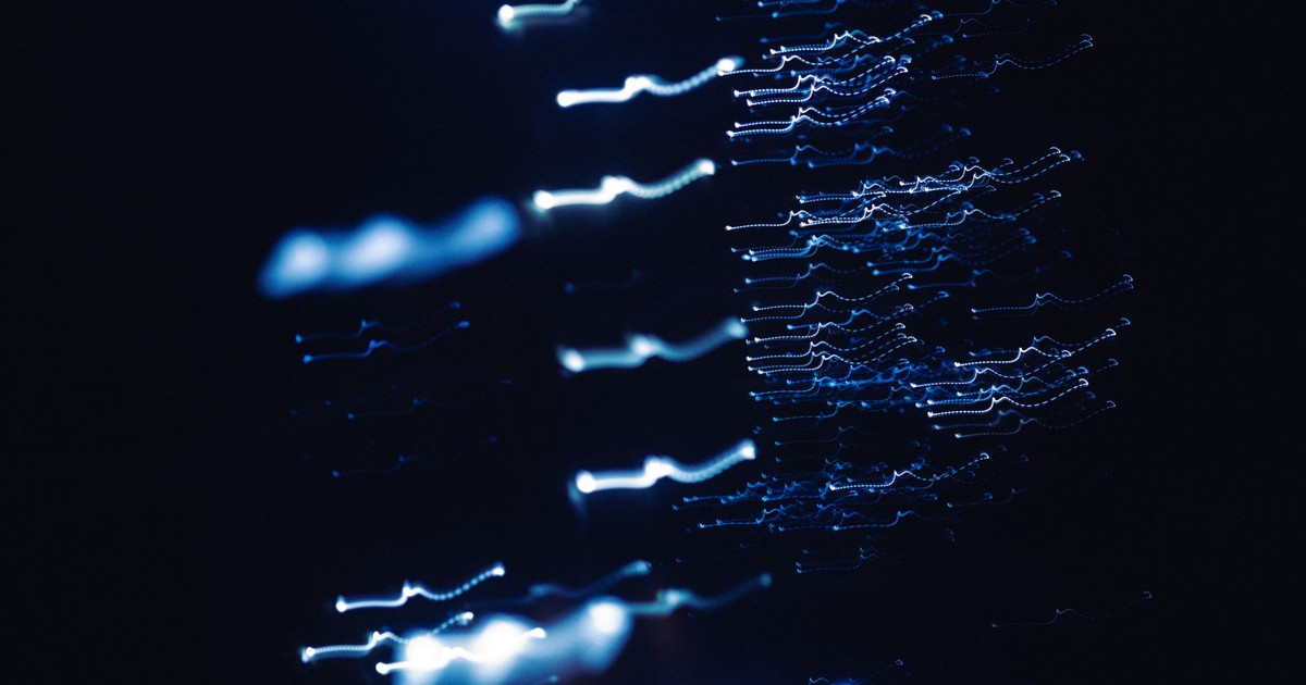 Dynamic abstract photograph of blue light patterns with a dark backdrop, creating a sense of motion and mystery.
