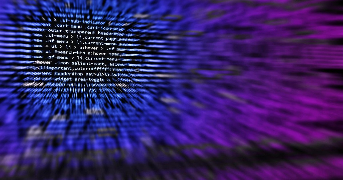 Dynamic abstract background featuring computer code in focus with blurred effect.