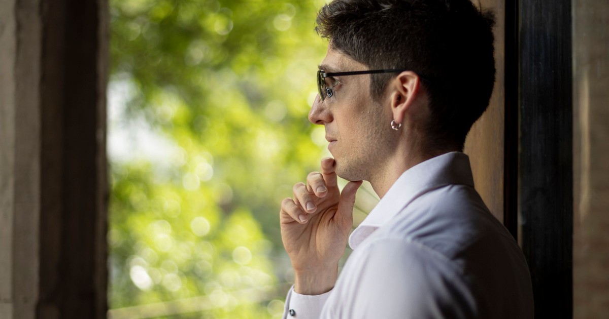 Side profile of a man in sunglasses contemplating by a window in Buenos Aires, Argentina