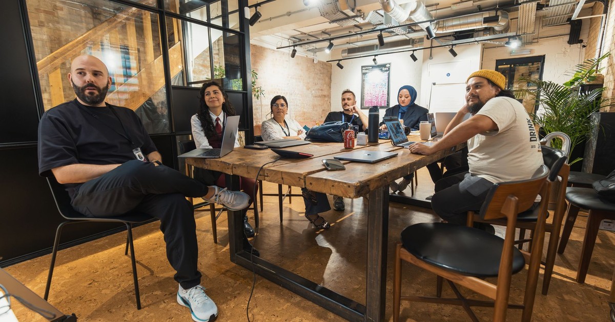 Diverse team engaged in a collaborative meeting in a contemporary office space.