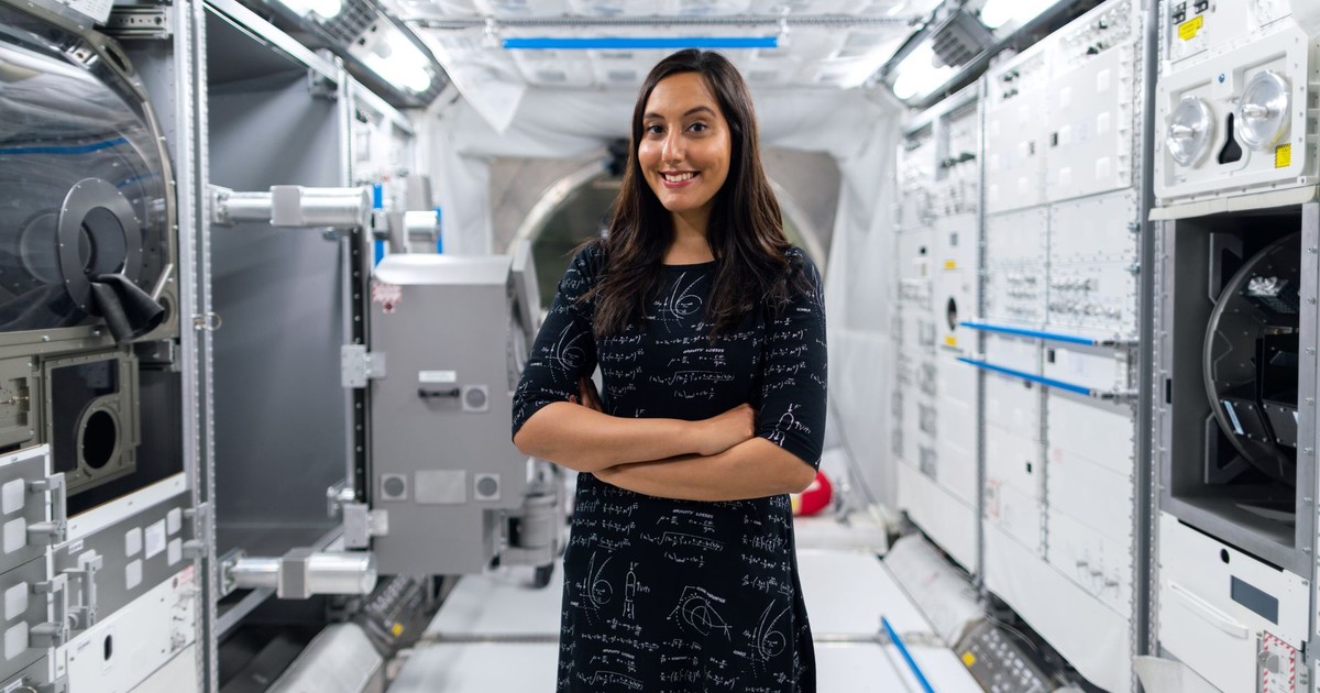 A smiling female scientist in a futuristic space station, symbolizing innovation and exploration.