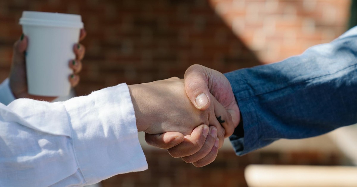 Close-up of a handshake between two adults, symbolizing agreement or partnership.