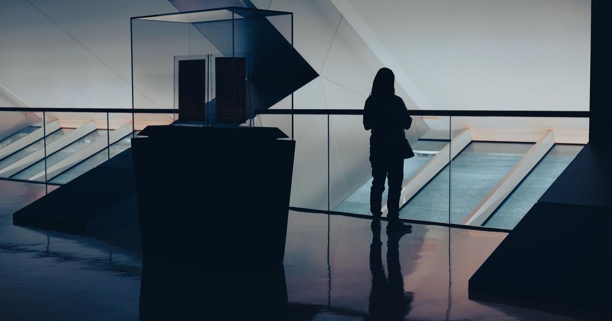 A striking silhouette of a person in a modern architectural setting, creating an artistic ambiance.