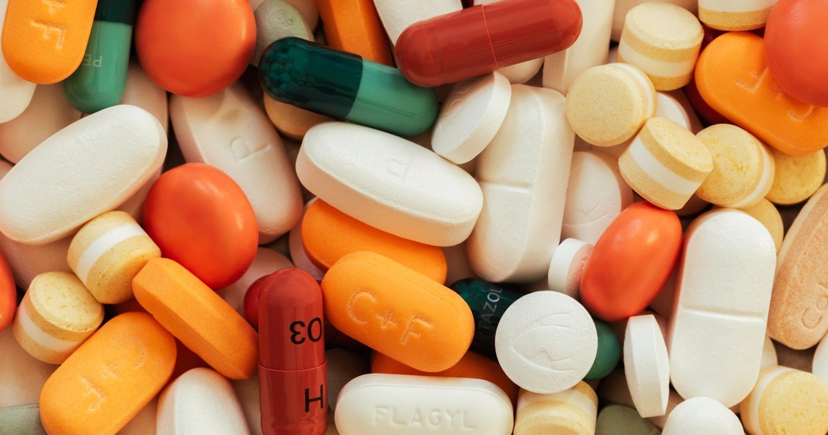 Close-up of assorted colorful pills and tablets on a surface.