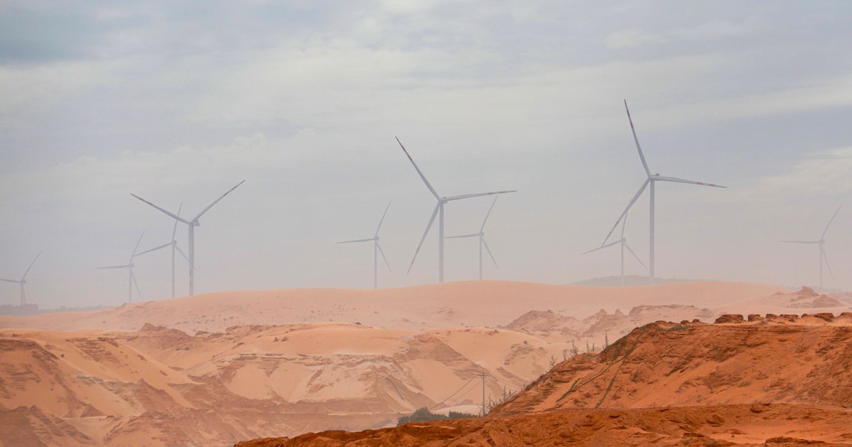 Wind turbines standing tall in the Bình Thuận desert, showcasing renewable energy.