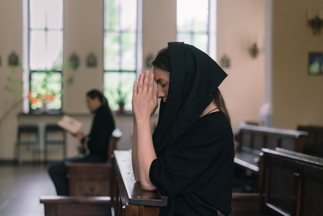 woman in black dress in church