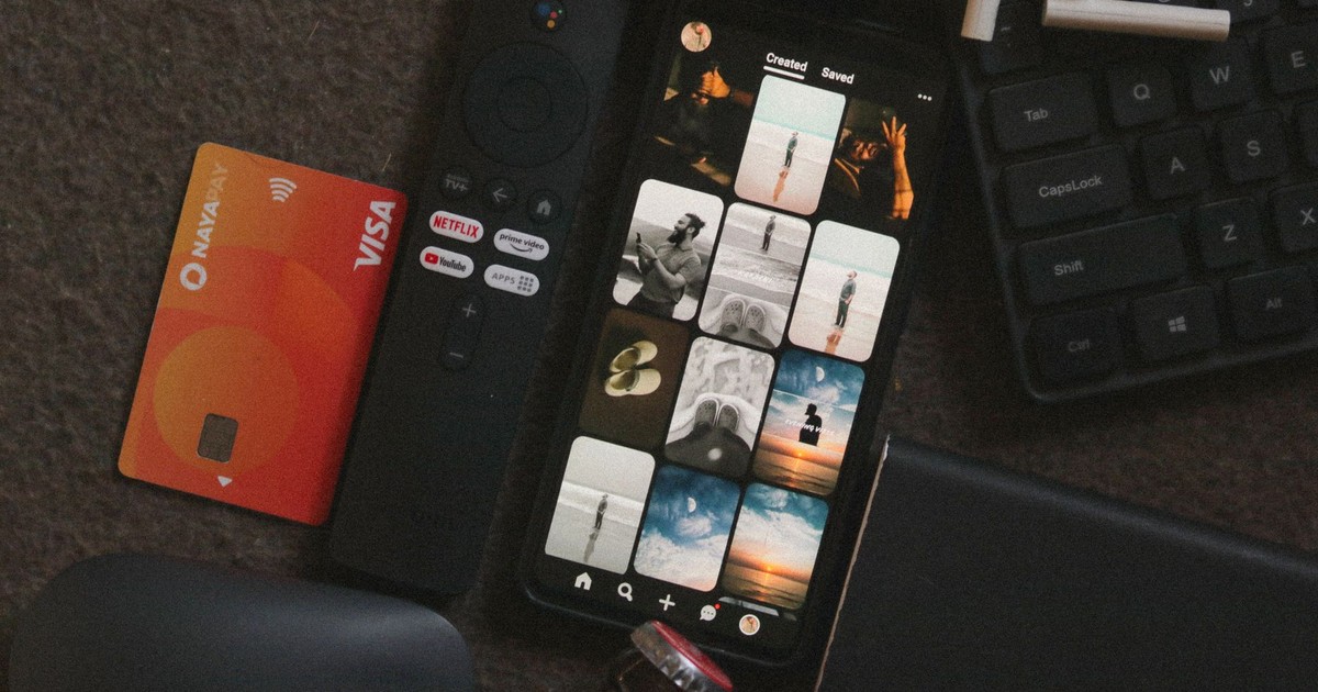 Flat lay of a smartphone, remote control, credit card, and gadgets for a tech-savvy lifestyle.
