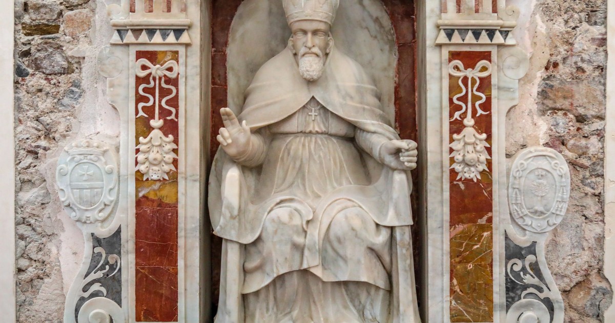 Beautiful marble sculpture of a pope in a historic Sicilian church, highlighting Italy's rich cultural heritage.
