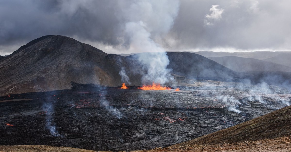 Captivating image of an active volcanic eruption with smoke and lava flow.