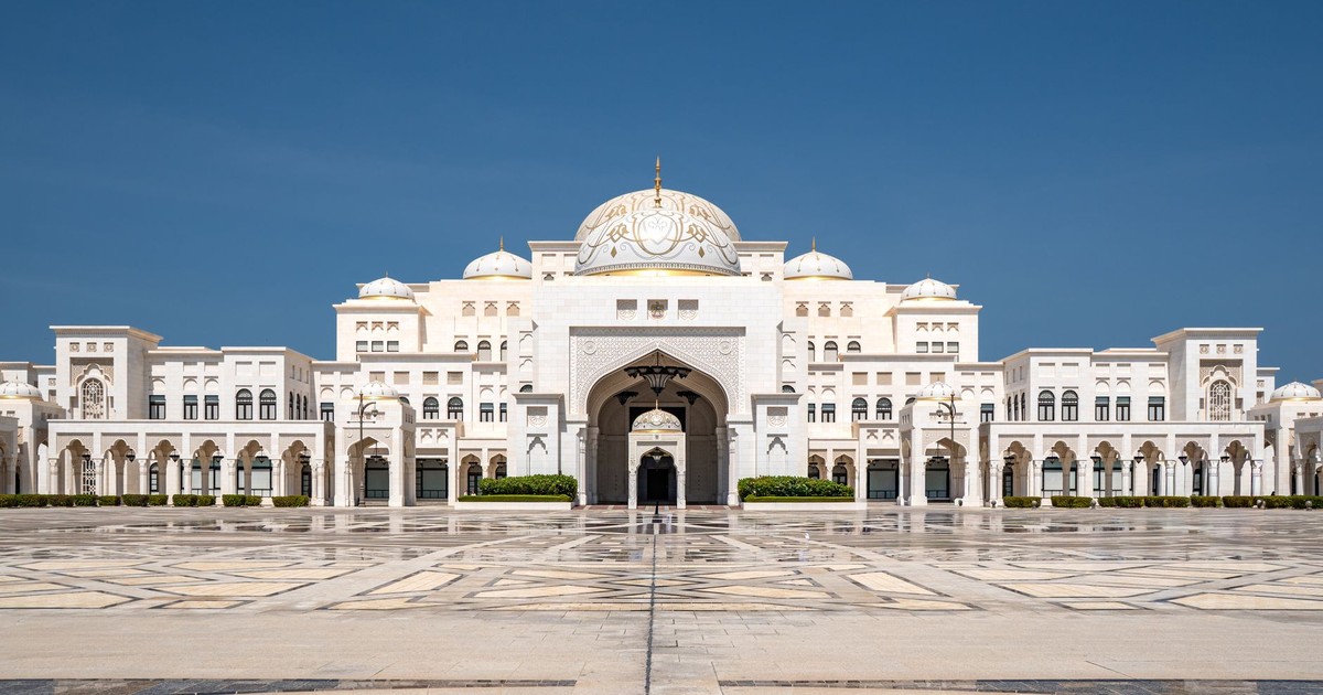 Front view of Qasr Al Watan Palace against a clear blue sky in Abu Dhabi, showcasing its grand architecture.