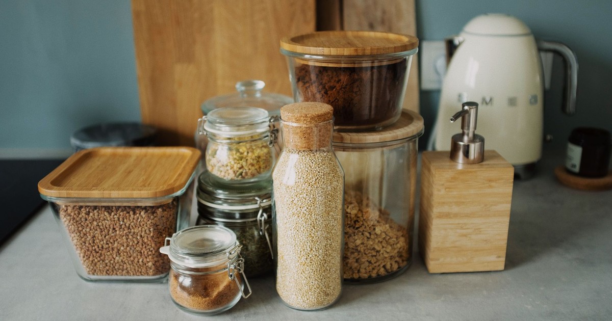 Stylish kitchen setup with glass jars, wooden accents, and a white electric kettle. Ideal for organization.
