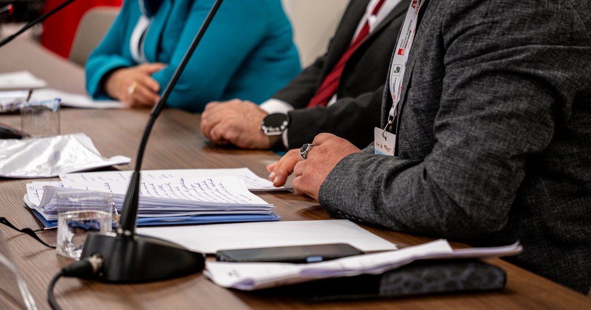 Close-up of professionals discussing documents at a business meeting in Ankara, Turkey.