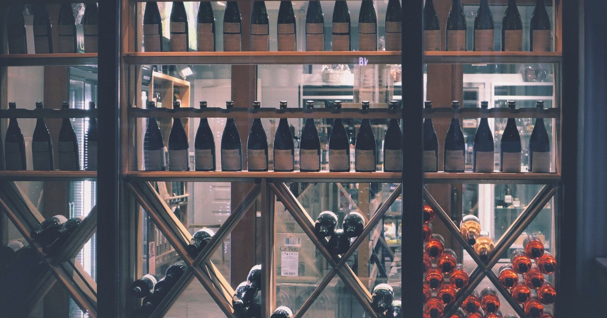 A beautifully arranged wine display in a market setting, featuring diverse bottles.