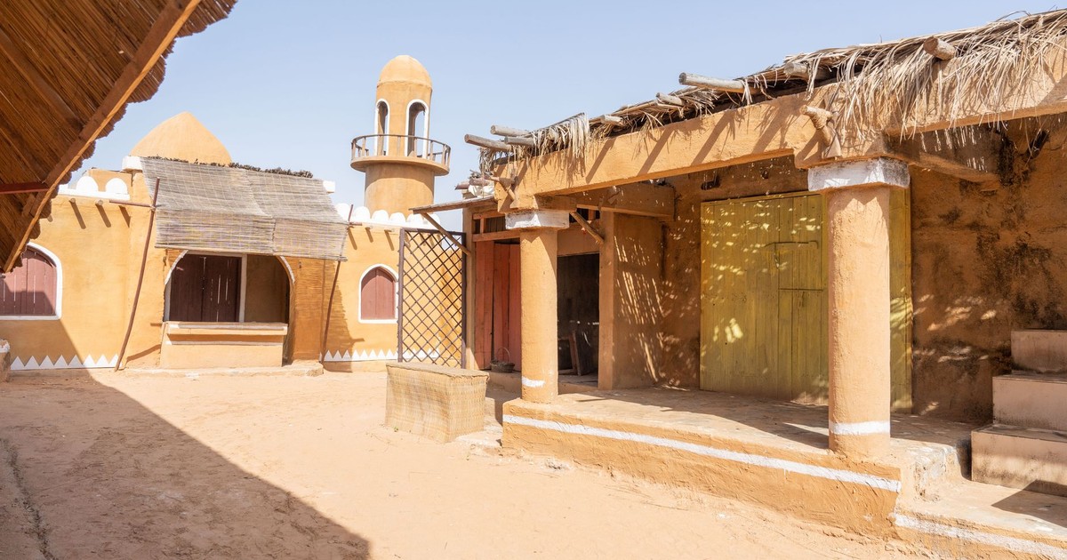Explore the rustic charm of traditional mud-walled desert village architecture.