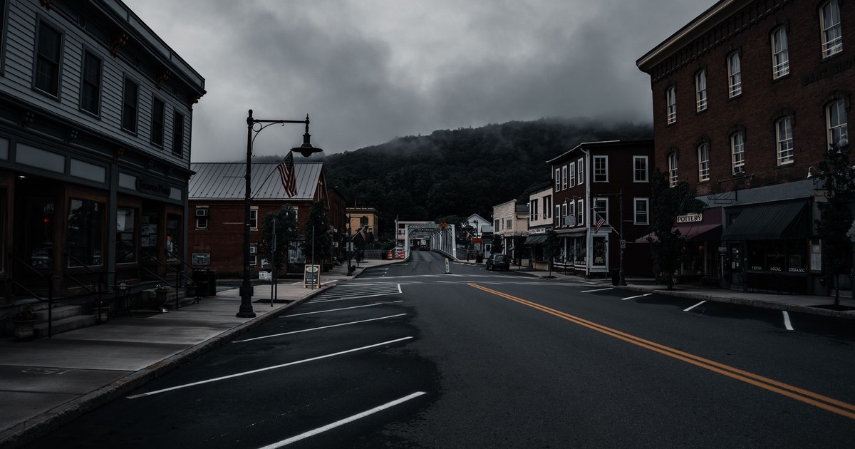 Empty town street with historic buildings and moody clouds. Perfect for travel or urban exploration themes.