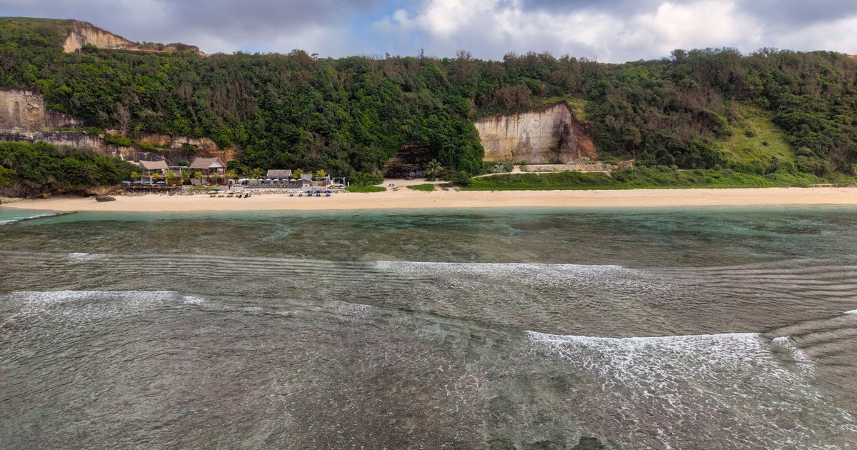 Serene Bali beach with clear waters and lush greenery, perfect for travel inspiration.