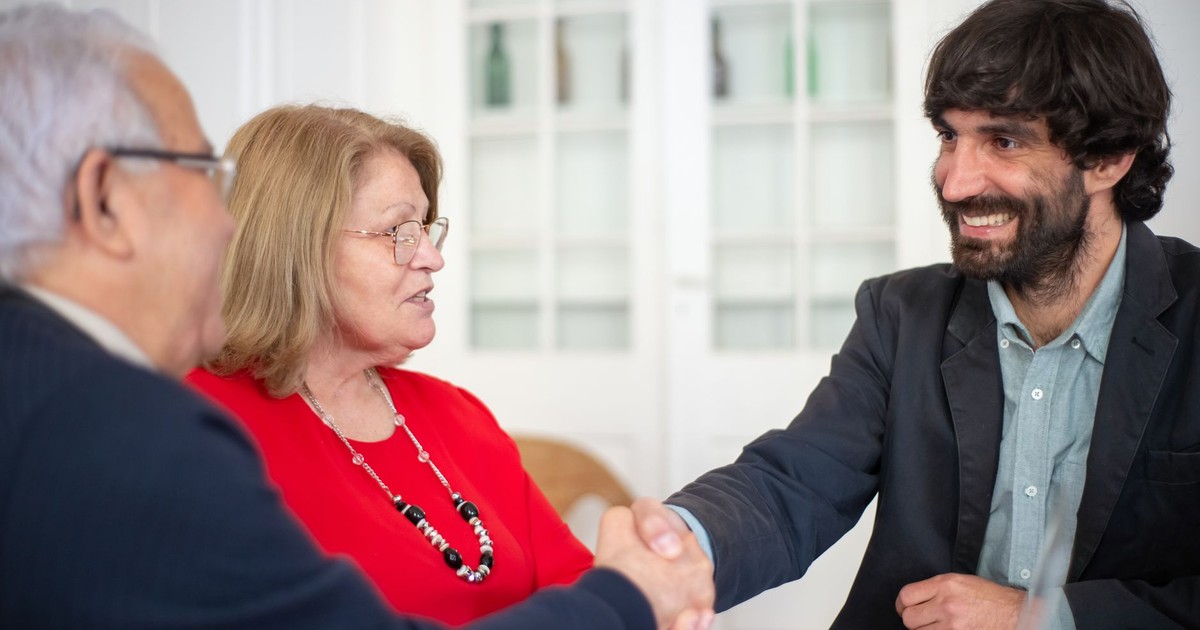 Business professionals engaged in a positive office meeting, sealing a deal with a handshake.