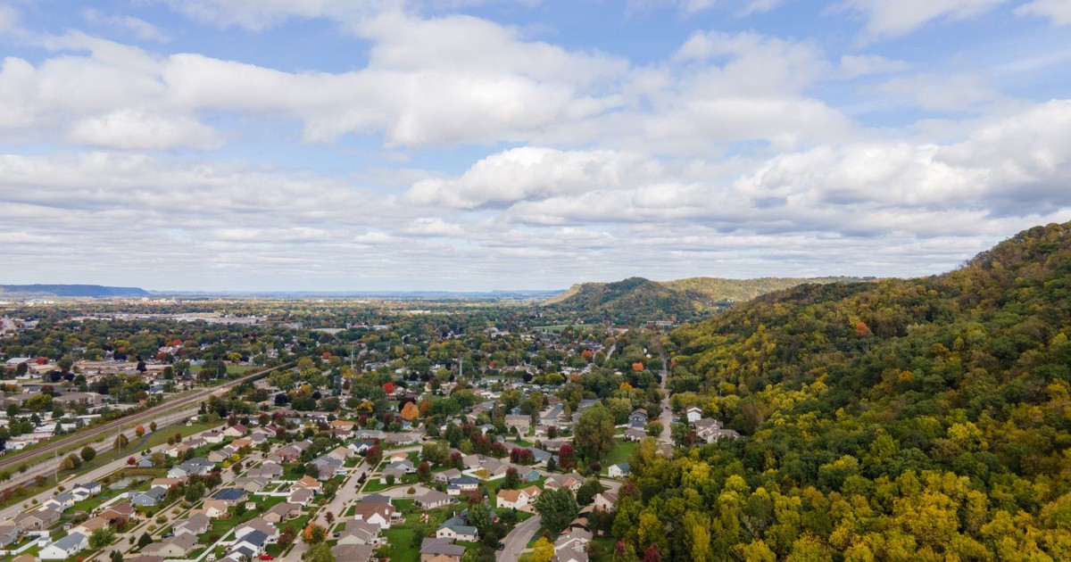 A stunning aerial view of residential neighborhoods beside lush forests in La Crosse, Wisconsin.