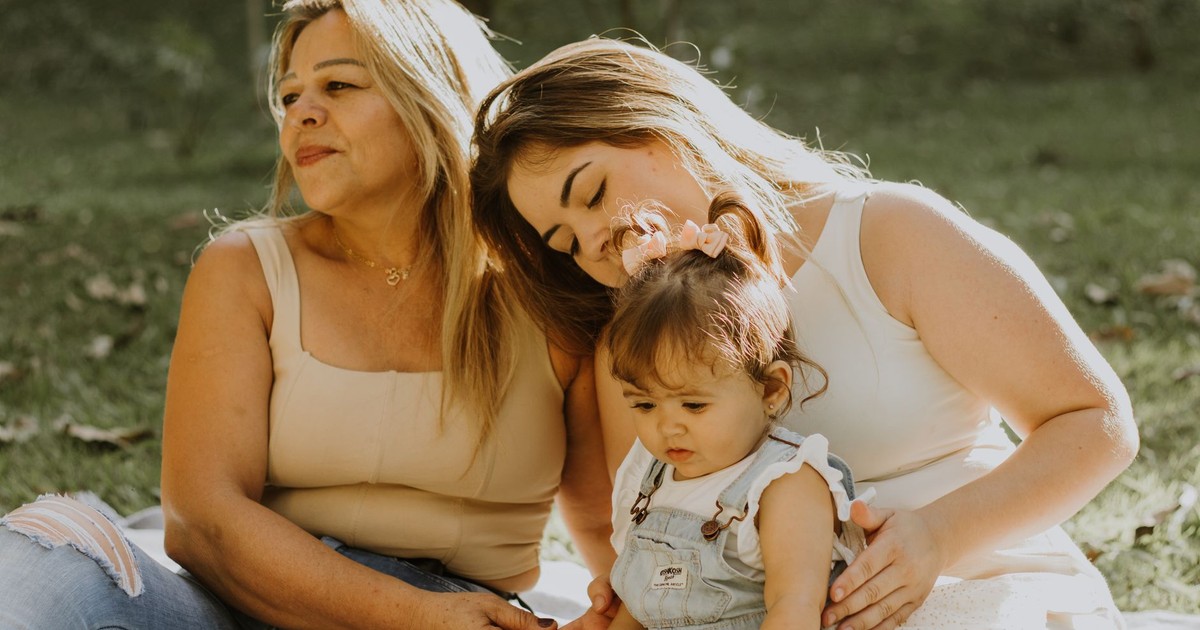 Three women of different ages enjoying a sunny day outdoors, capturing familial bonding moments.