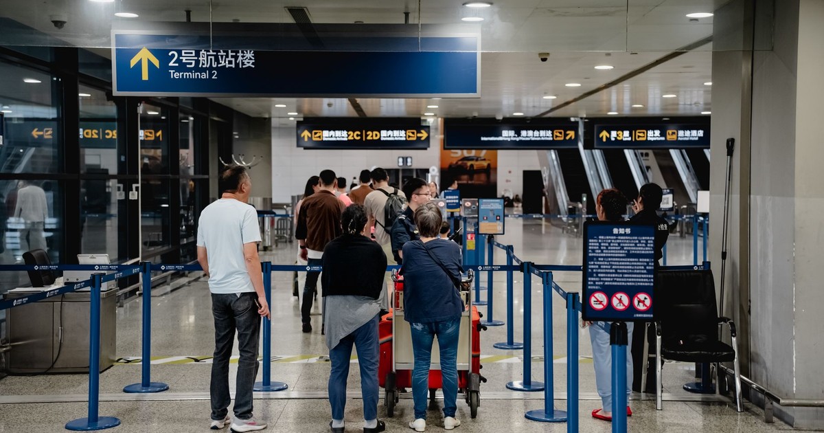 Passengers queue at Terminal 2 in Shanghai Airport, China.