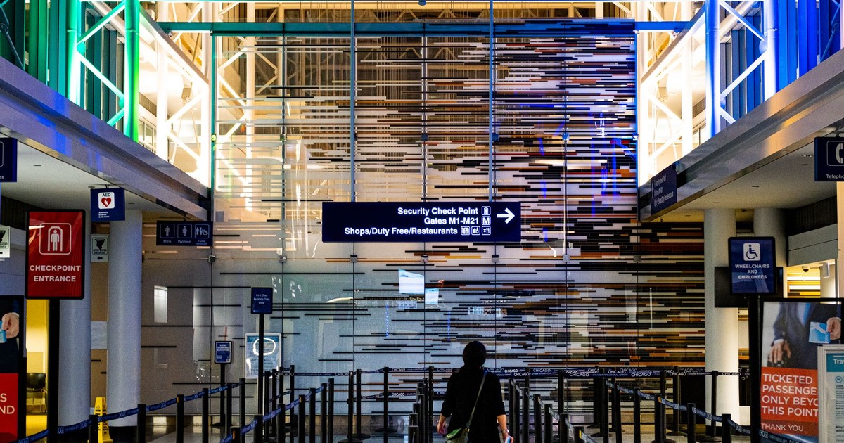 A traveler enters the security checkpoint at O'Hare Airport terminal, Chicago.