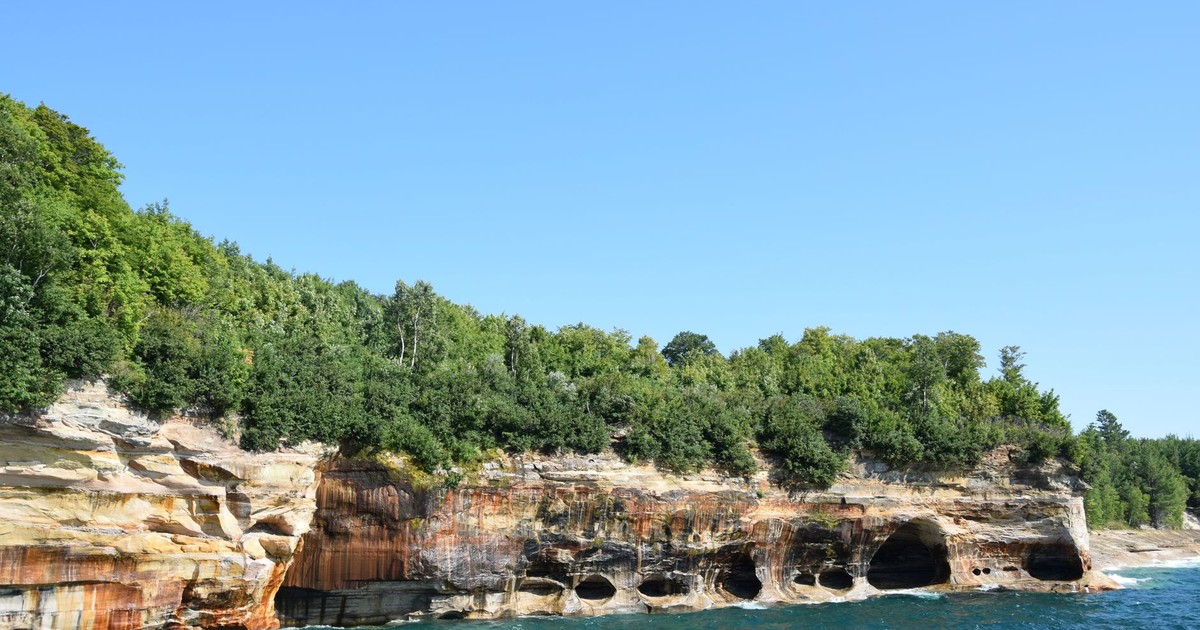 Stunning view of Pictured Rocks cliffs and clear blue water in Michigan's Upper Peninsula.