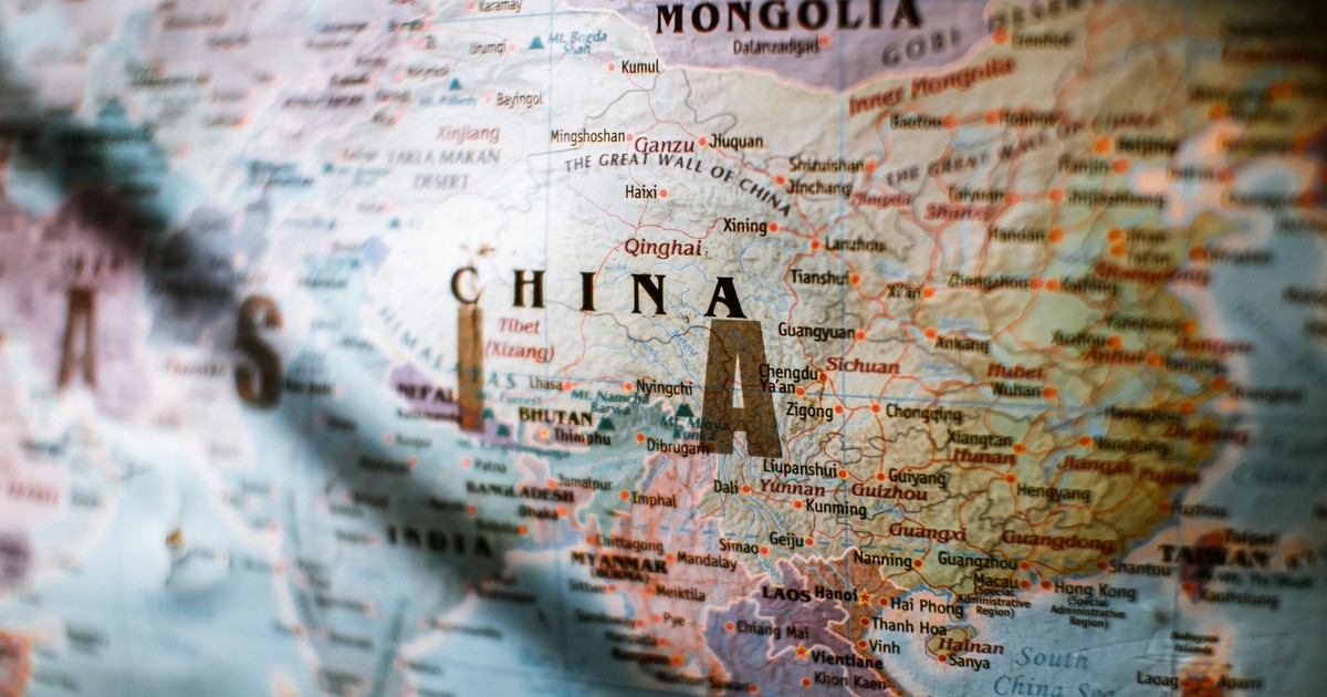 Paper political world map with Asian countries borders and coastline near water