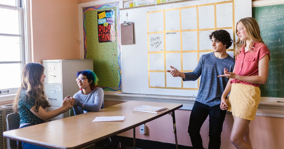 Students interacting in a high school classroom with a focus on engagement and collaboration.
