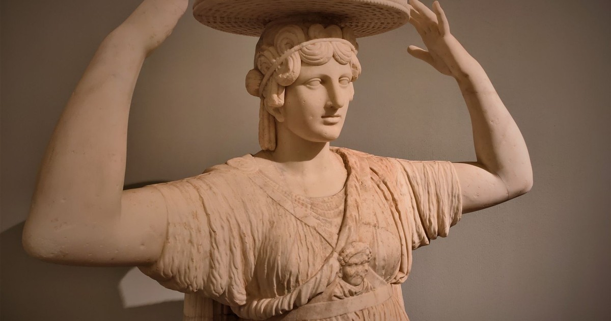 Elegant stone sculpture of a caryatid woman in Rome, Italy, showcasing ancient Greek artistry.