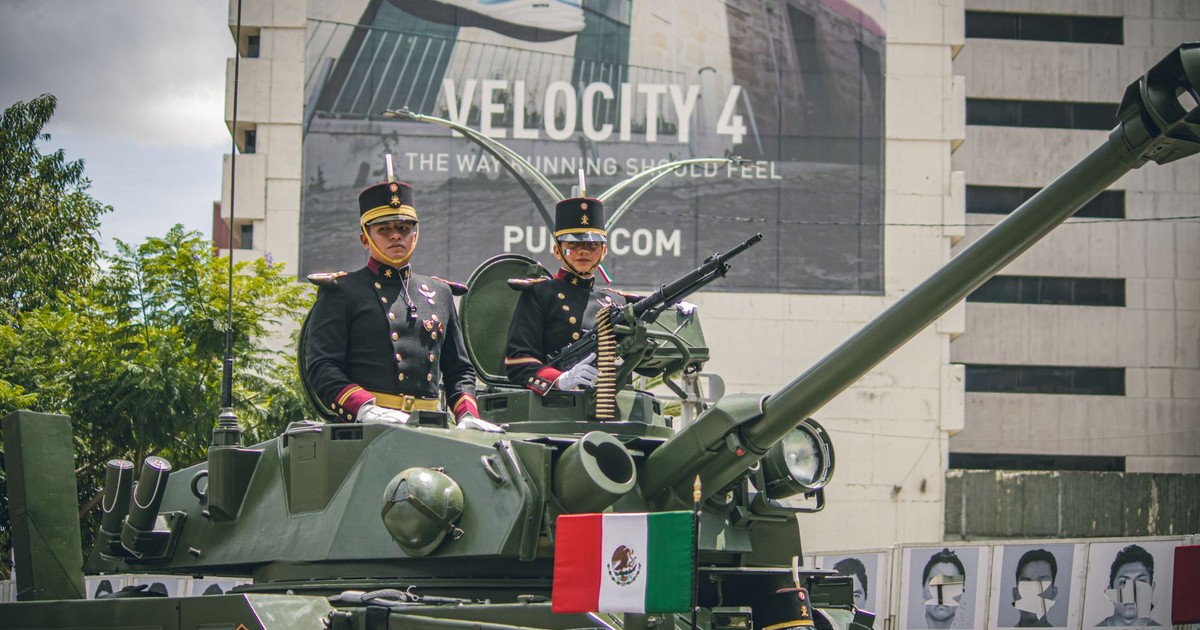 Mexican soldiers in uniform on a tank during a military parade in Mexico City.
