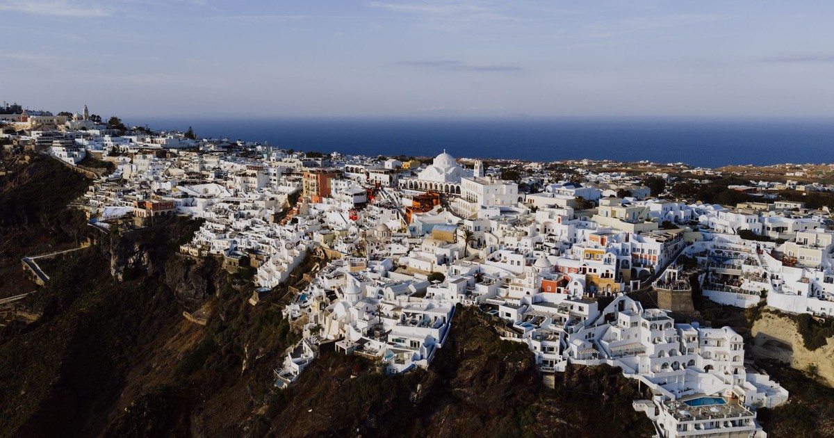 Stunning aerial view of Fira's iconic white architecture against the Aegean Sea.
