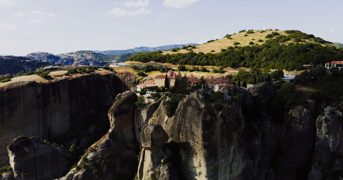 A breathtaking aerial view of a Meteora monastery perched atop rock formations in Greece.