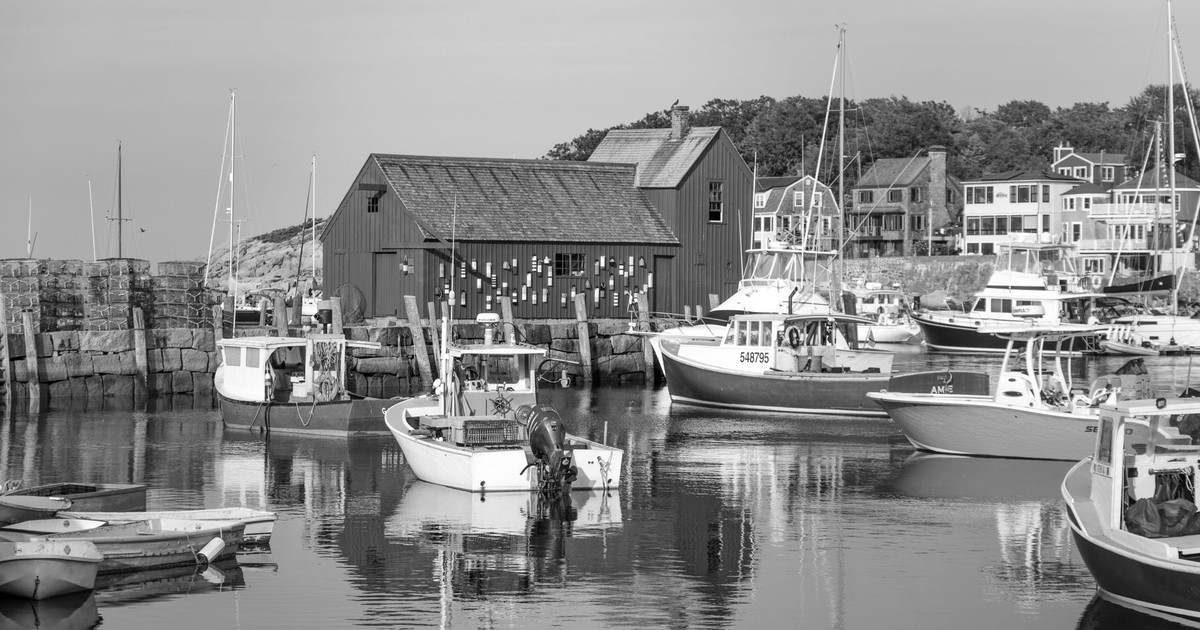 Scenic view of fishing boats at Rockport Harbor with the iconic Motif No. 1 in black and white.