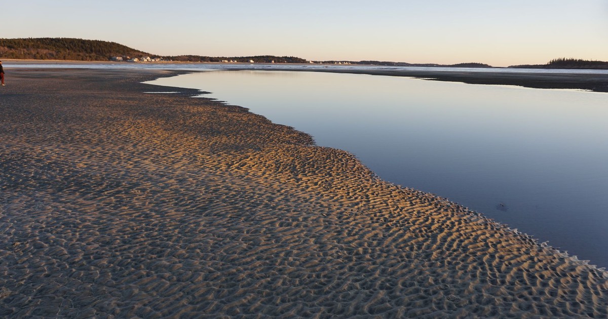 Scenic coastline at dawn with calm ocean and serene landscape, perfect for travel inspiration.