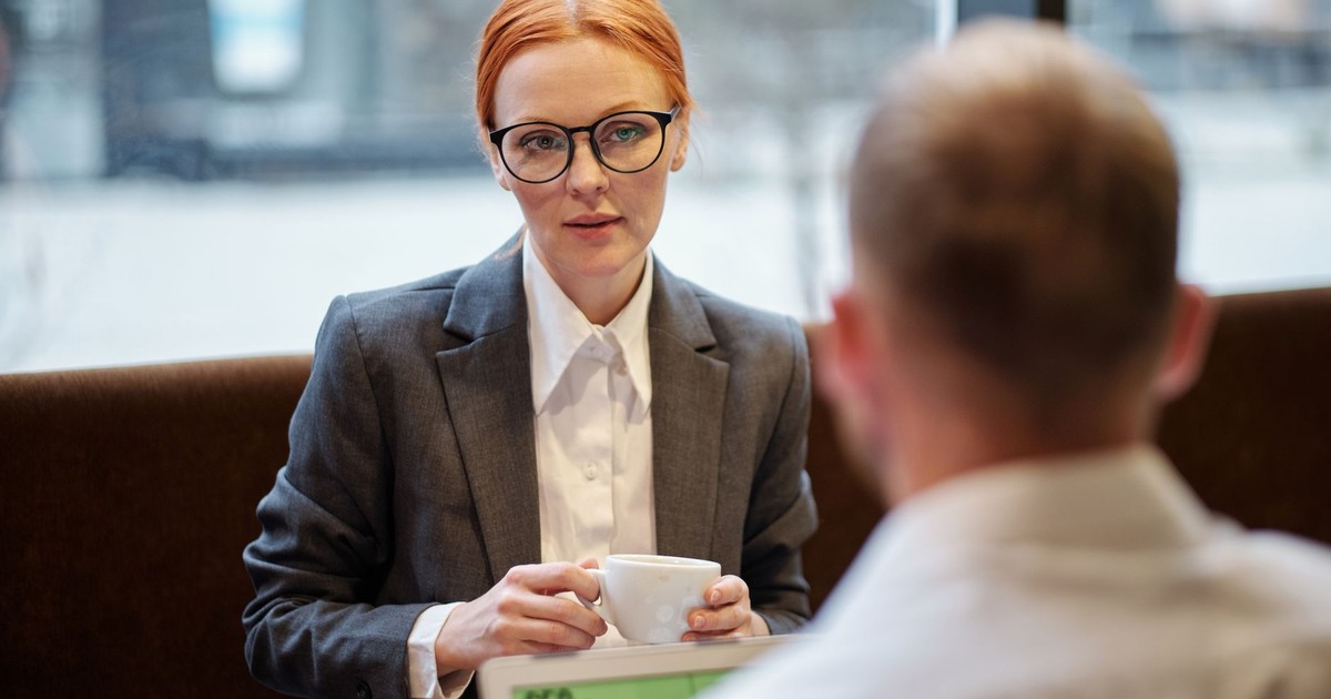 Businesswoman having a corporate meeting with coffee in a casual setting.