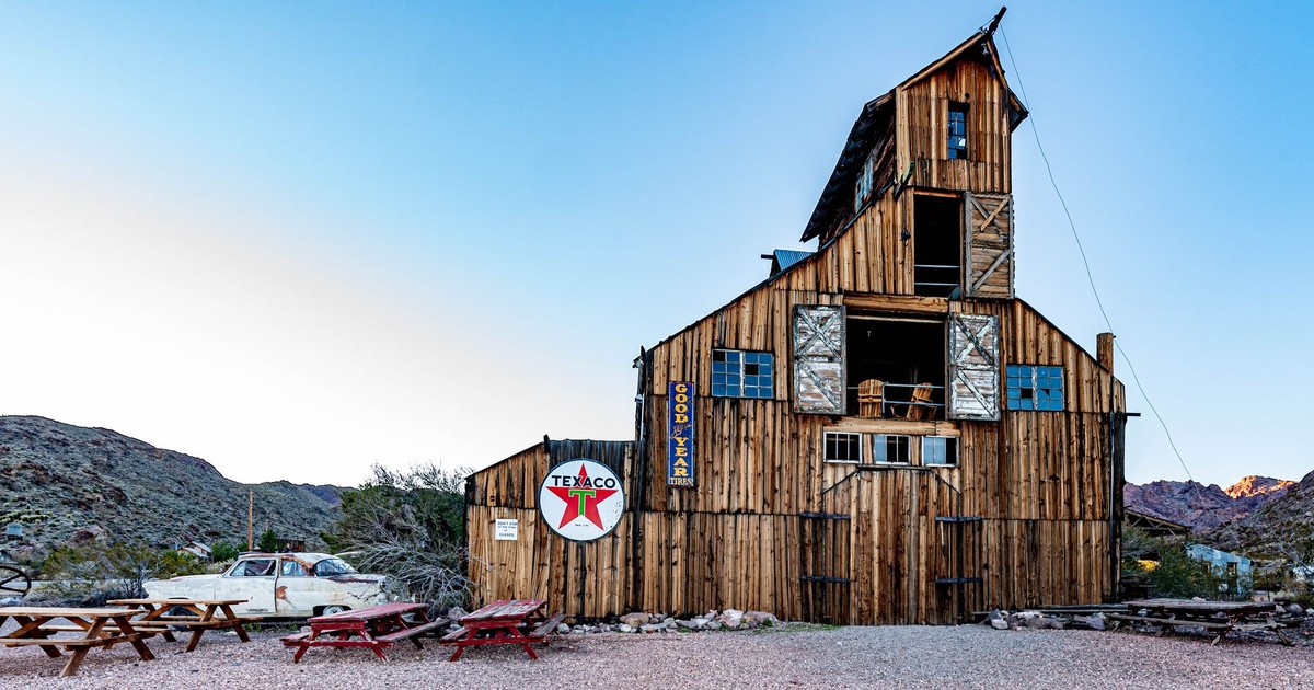 A vintage wooden building in Nelson, Nevada, featuring Texaco signage and a desert backdrop.
