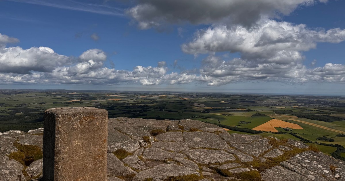Breathtaking view from Bennachie summit, showcasing vast landscapes and dramatic clouds.