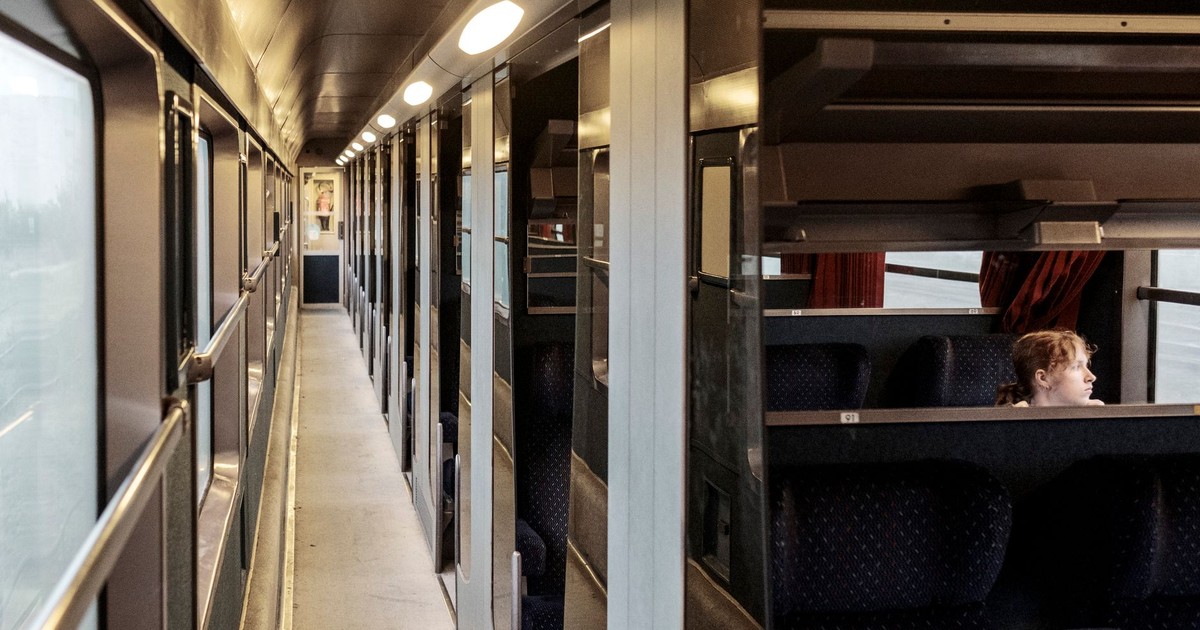 A young girl sitting alone in a train cabin, traveling through France. Peaceful and serene ambiance.