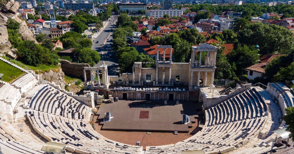 Stunning aerial view of the historic Roman Theatre in Plovdiv, Bulgaria, amidst urban landscape.