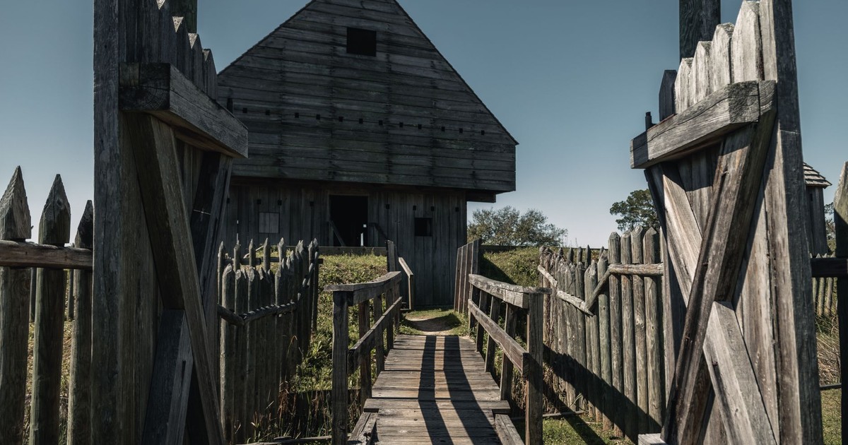 Explore the wooden structure of Fort King George, highlighting its historic architecture under a clear blue sky.