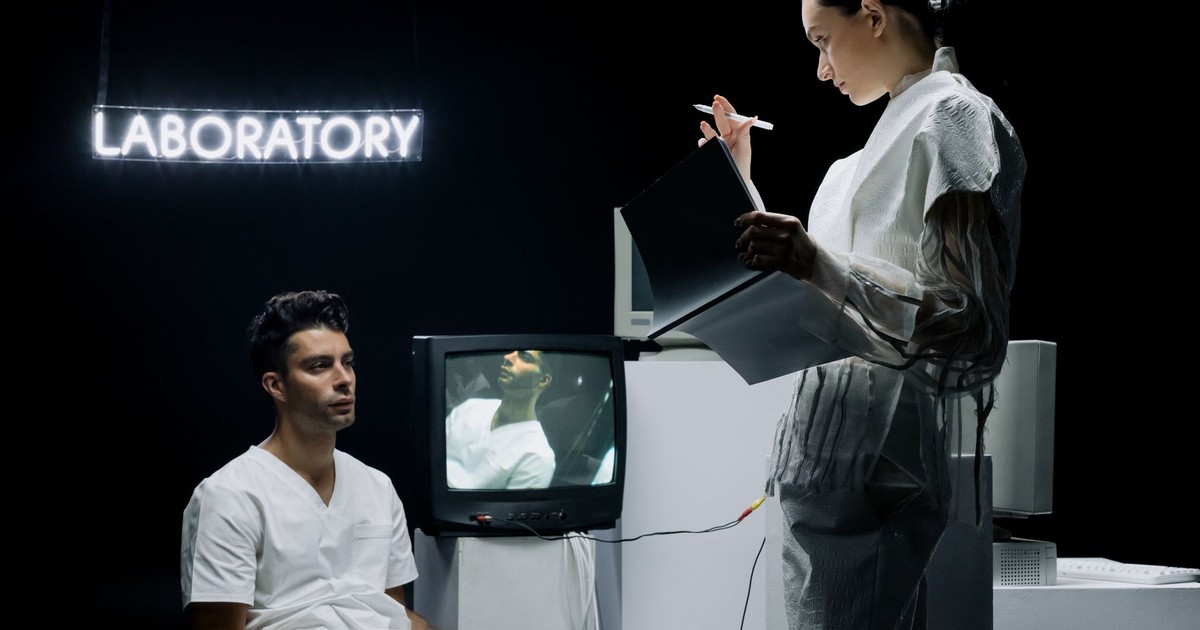 Two scientists in a futuristic laboratory setting analyzing data and conducting research on a subject.