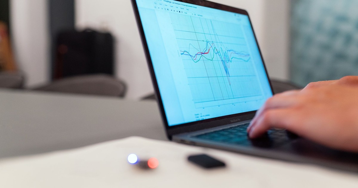 A person working on a graph analysis on a laptop for data monitoring and research.