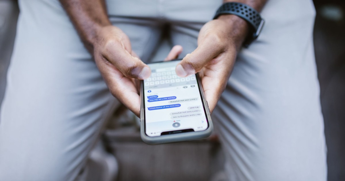Close-up view of a man texting on a smartphone, capturing communication in action.