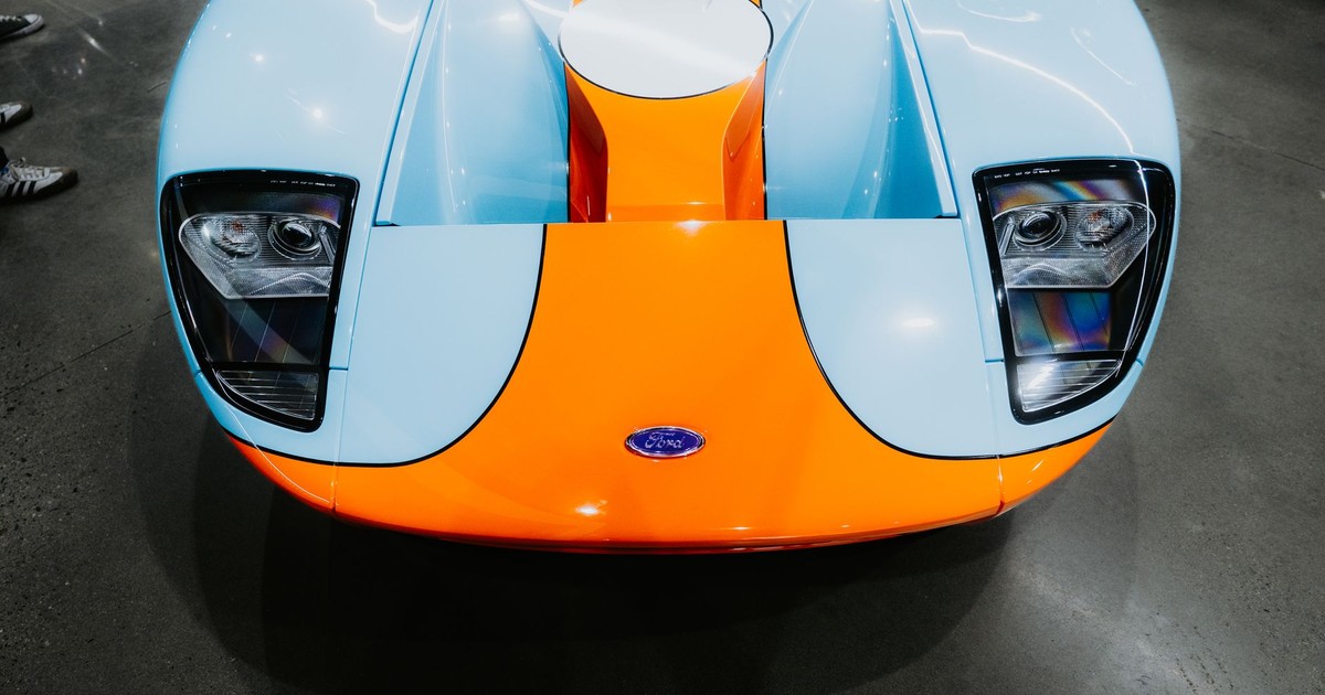 Front view of a vintage blue and orange sports car, showcasing its iconic design and vibrant colors.
