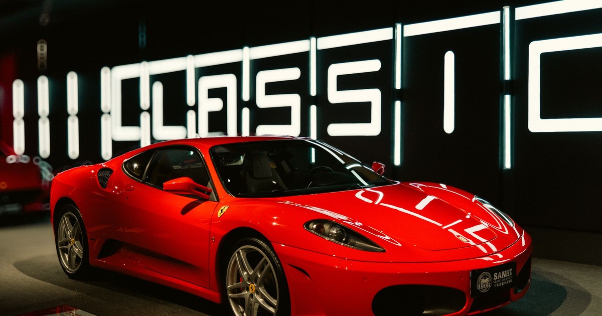 Vibrant red sports car displayed in a modern and stylish showroom with classic design.