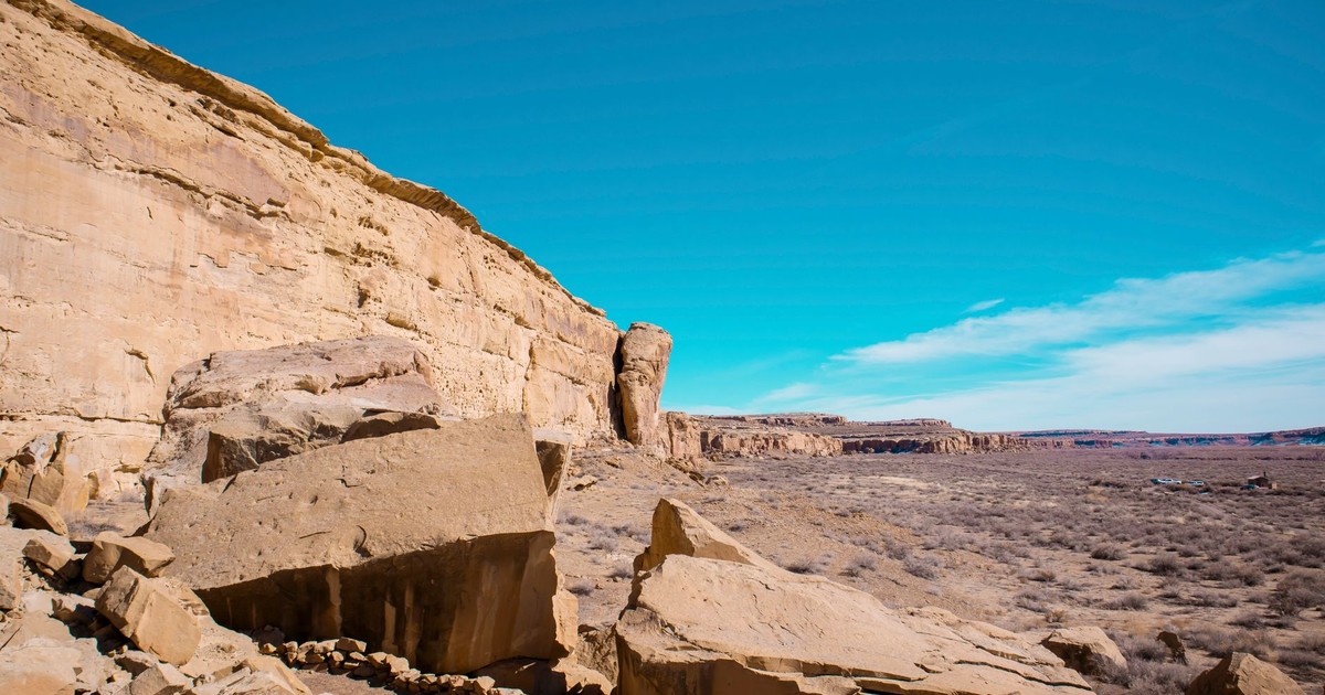 Breathtaking view of sandstone cliffs under a clear blue sky in the New Mexico desert.