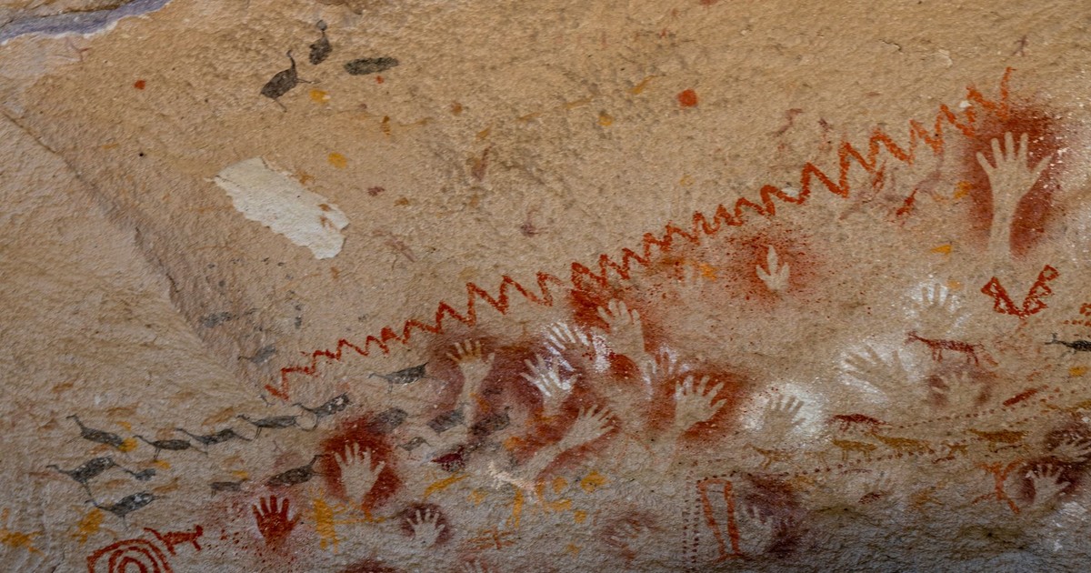 Historic cave art featuring stenciled hands at Cueva de las Manos in Santa Cruz, Argentina.