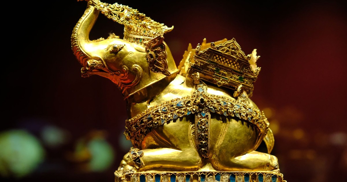 Intricate golden elephant statue with Thai traditional design, photographed in Ayutthaya, Thailand.