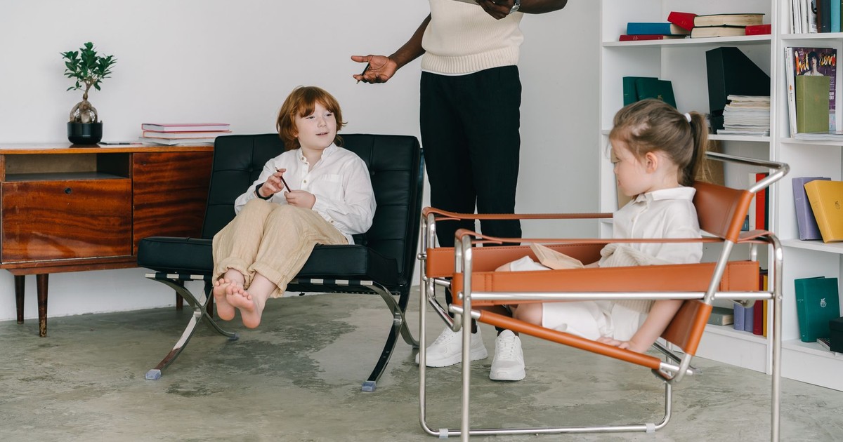 Children engaging in a therapy session with therapist in a modern office.