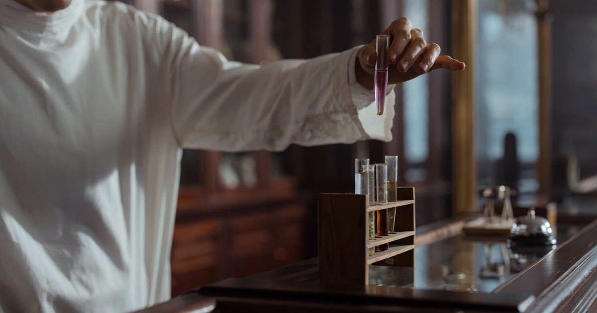 Pharmacist in classic lab holding test tube with liquid, vintage style.